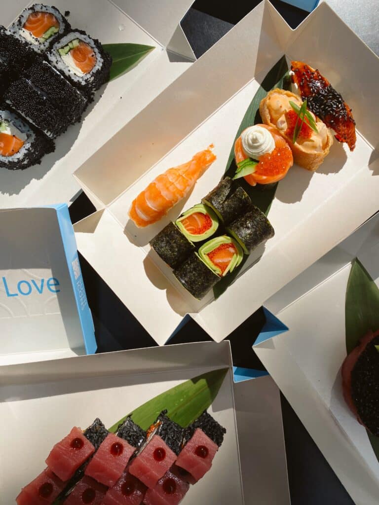 Assorted sushi on paper boxes