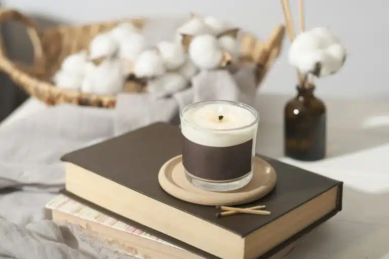 hygge concept. cozy ambient home interior decor with candle, cotton buds and aroma diffuser.